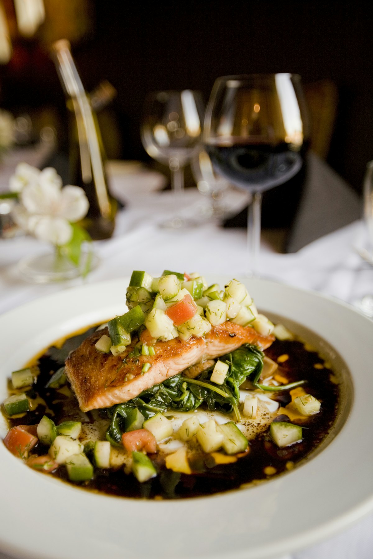 Filet de poisson sur lit d'épinards et légumes en dés